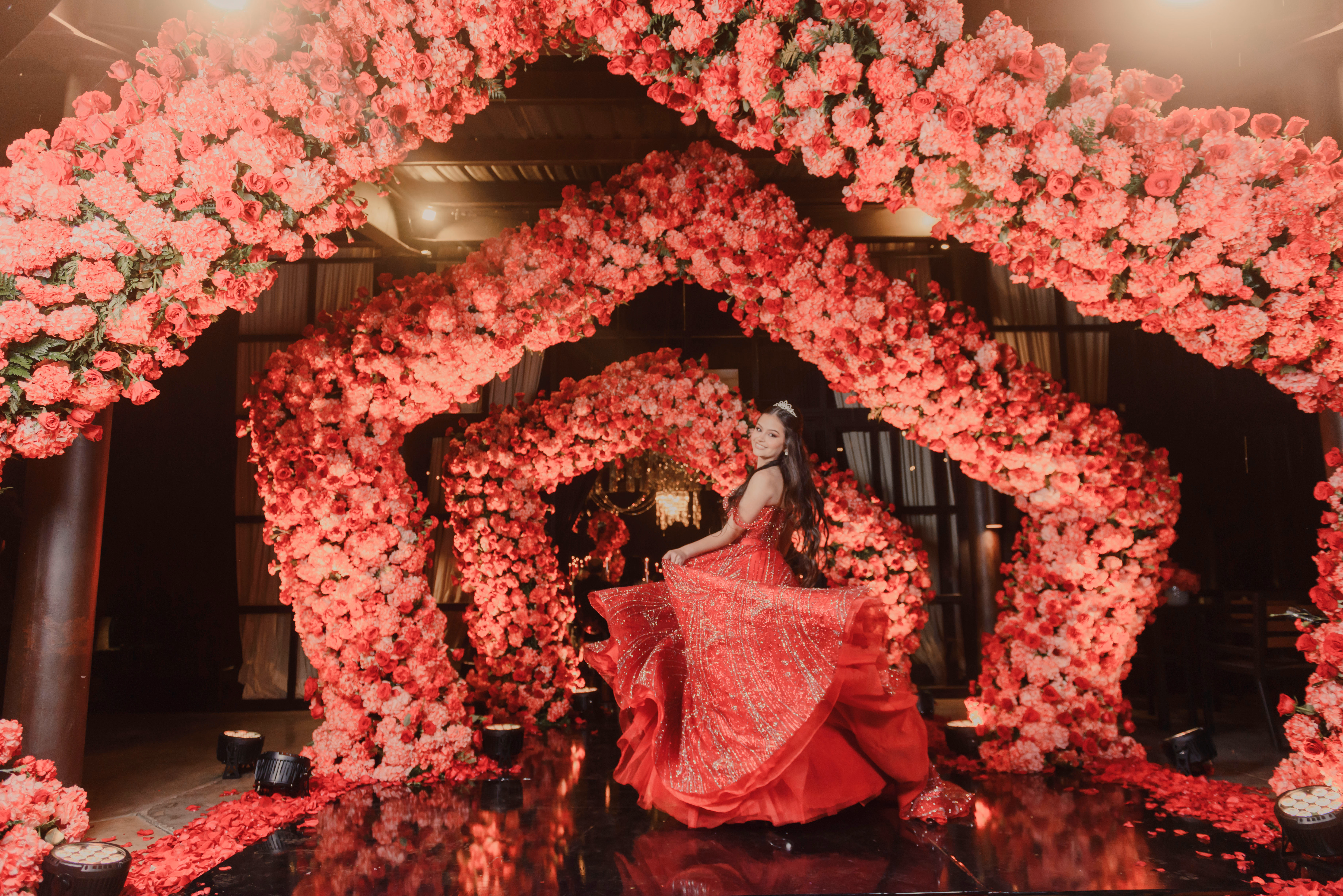 Quinceañera in a red gown at an elegant celebration